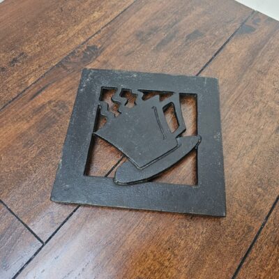 Hudson's Bay Company Cast Iron Trivet with Coffee Cup Design - product image 1